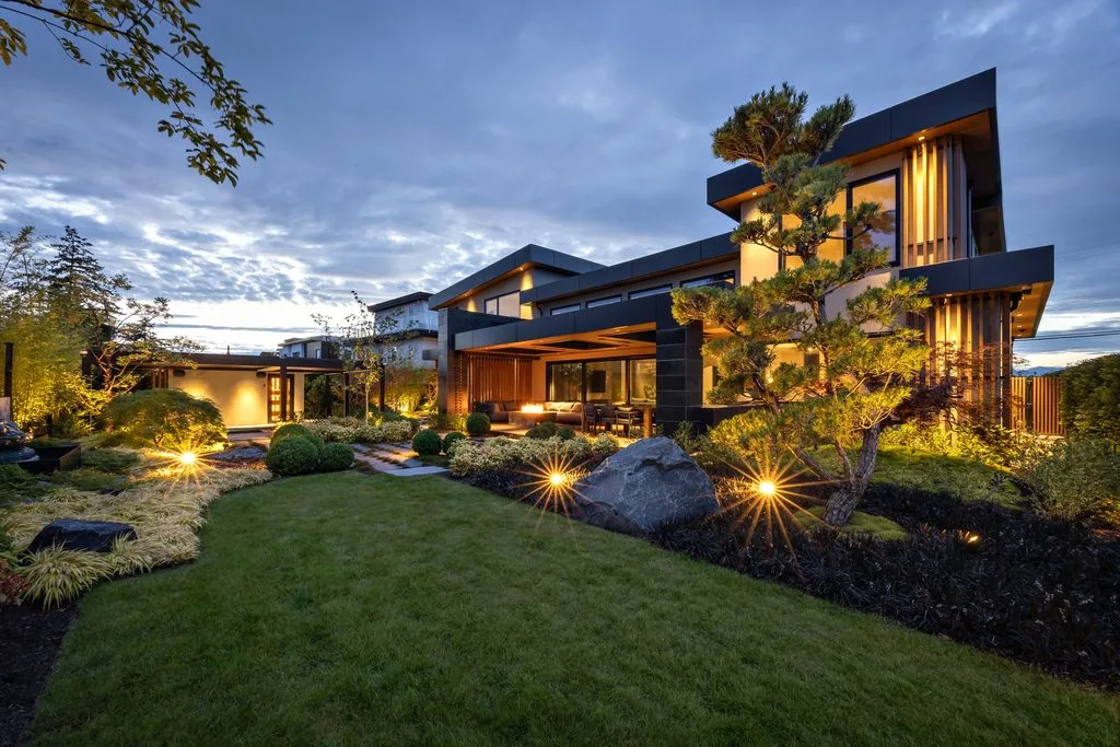 Swicks_4280_River_Web-53-2578 - Swick's Landscaping Ltd. Contemporary house with a well-lit backyard garden at dusk, warm outdoor lights and manicured landscaping.