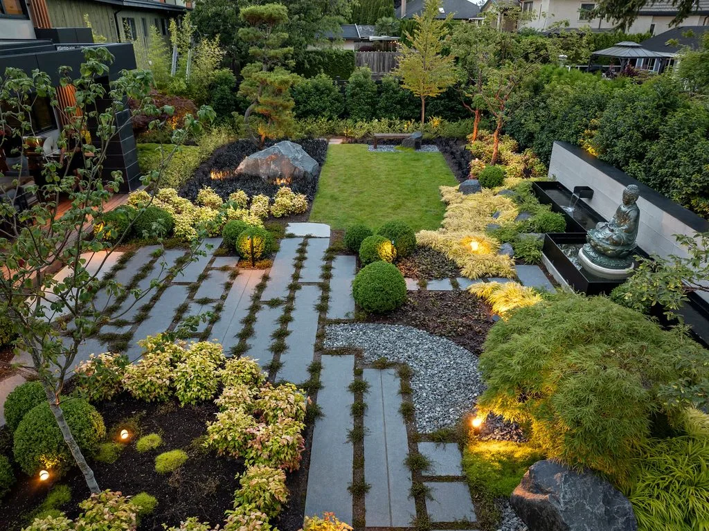 Swicks_4280_River_Web-82-0341 - Swick's Landscaping Ltd. A modern Japanese-style garden with stone steps, trimmed shrubs, and a small Buddha fountain on the right edge.